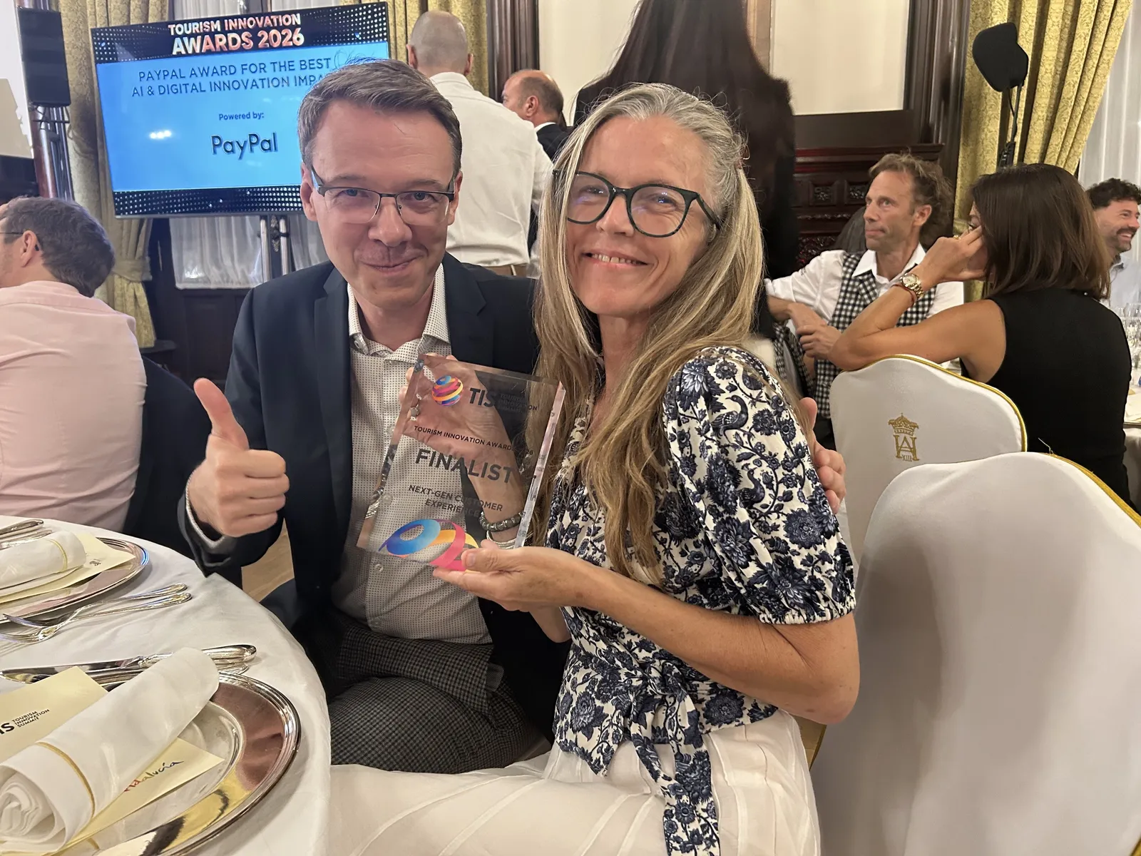 Kiwi.com representatives holding the finalist trophy at the Tourism Innovation Awards 2026 in Seville
